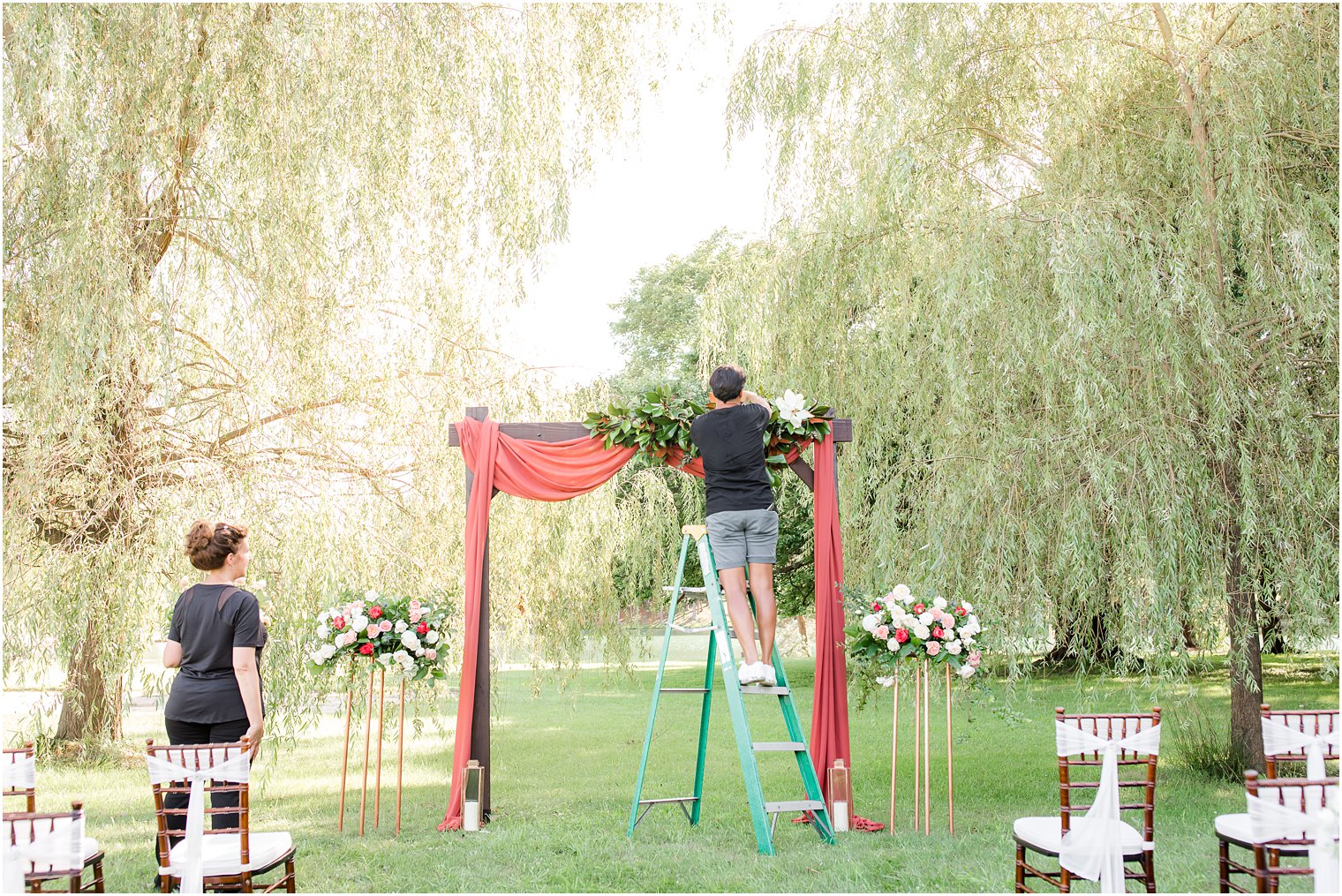 Florist setting up arbor for a styled shoot